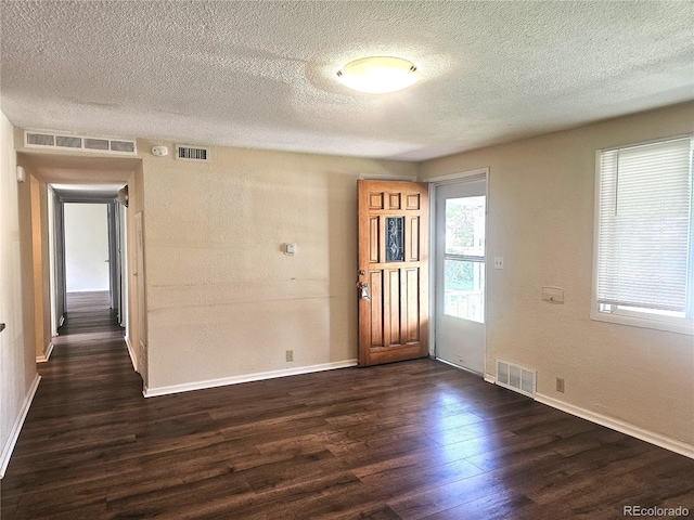 7331 Clay St, Westminster, CO 80030 - foyer entrance featuring dark wood-style floors and a textured ceiling