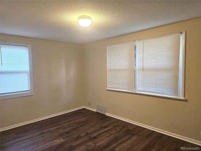 7331 Clay St, Westminster, CO 80030 - unfurnished room featuring dark wood finished floors and a textured ceiling