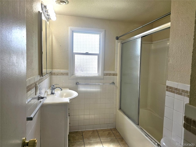 7331 Clay St, Westminster, CO 80030 - full bathroom featuring tile walls, vanity, tile patterned floors, combined bath / shower with glass door, and wainscoting