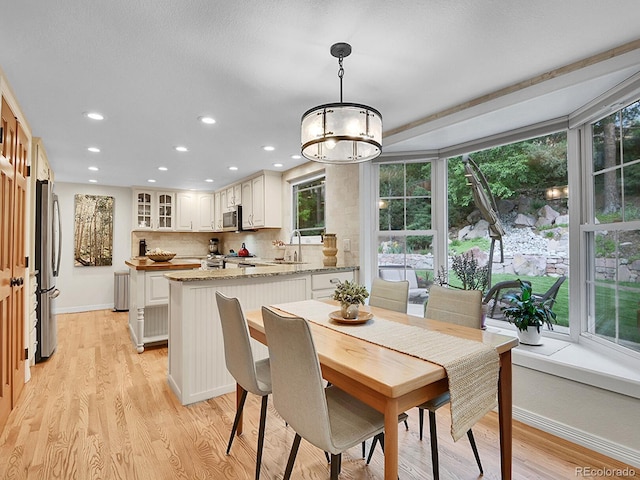 7030 S Fillmore Ct, Centennial, CO 80122 - dining space featuring recessed lighting, light wood finished floors, a chandelier, and baseboards
