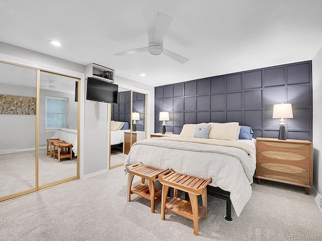 7030 S Fillmore Ct, Centennial, CO 80122 - bedroom featuring a decorative wall, light colored carpet, a ceiling fan, two closets, and recessed lighting