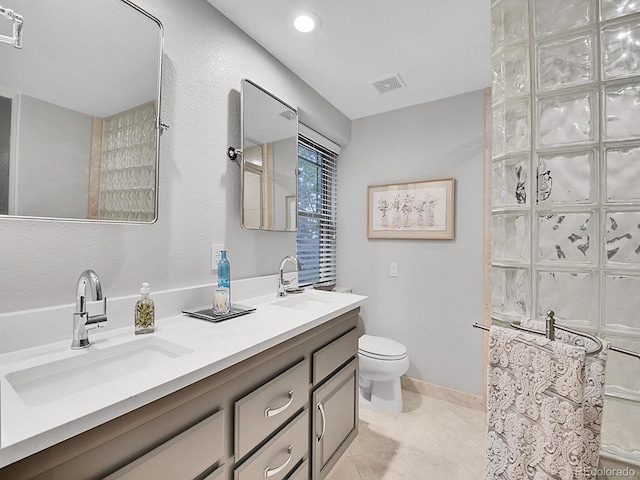 7030 S Fillmore Ct, Centennial, CO 80122 - bathroom featuring double vanity, toilet, and tile patterned floors
