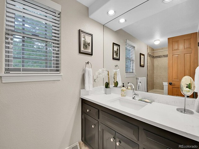 7030 S Fillmore Ct, Centennial, CO 80122 - bathroom with vanity, a textured wall, and recessed lighting