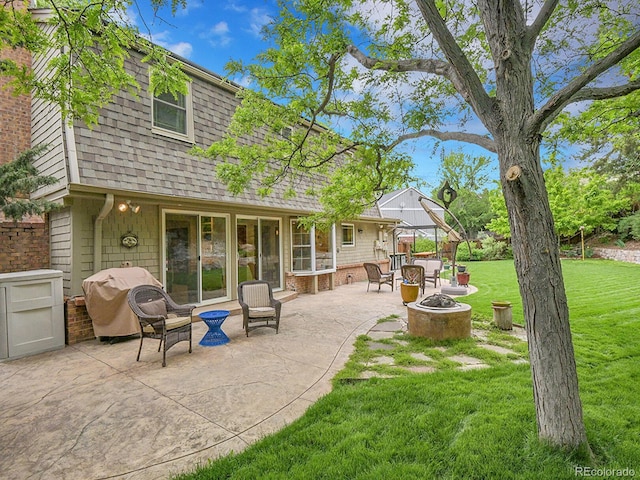 7030 S Fillmore Ct, Centennial, CO 80122 - back of house with an outdoor fire pit, a shingled roof, a yard, and a patio