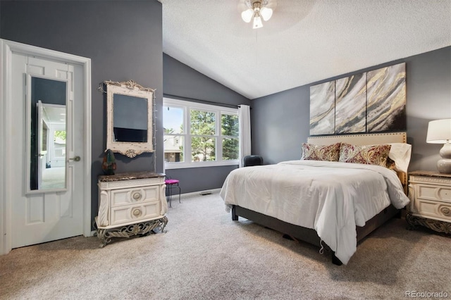 bedroom featuring ceiling fan, carpet floors, a textured ceiling, and lofted ceiling