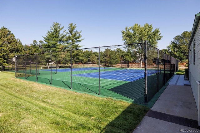 view of sport court with a yard