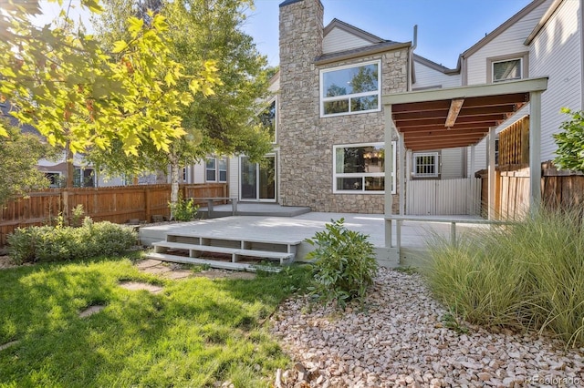 rear view of house featuring a deck