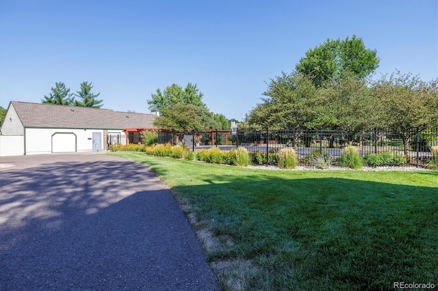 view of front of house with a garage and a front lawn