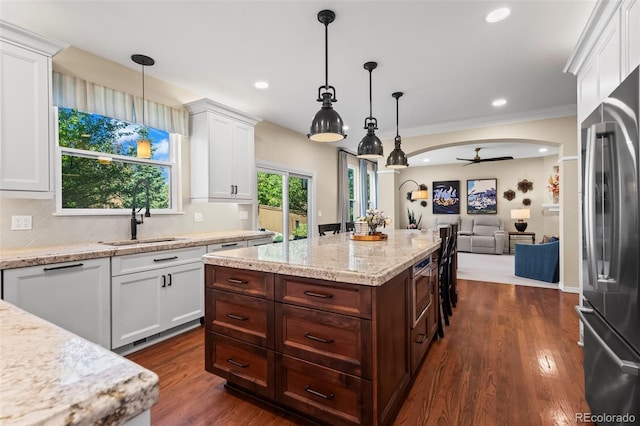 1113 Southbury Pl, Highlands Ranch, CO 80129 - kitchen with a sink, appliances with stainless steel finishes, white cabinets, dark brown cabinets, and recessed lighting
