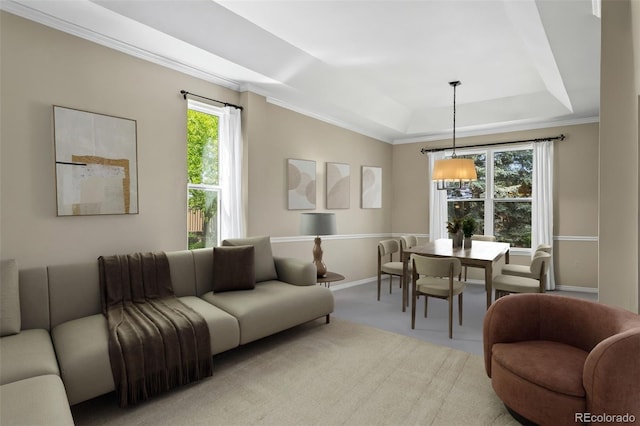 1113 Southbury Pl, Highlands Ranch, CO 80129 - living room featuring a raised ceiling, healthy amount of natural light, crown molding, baseboards, and a chandelier