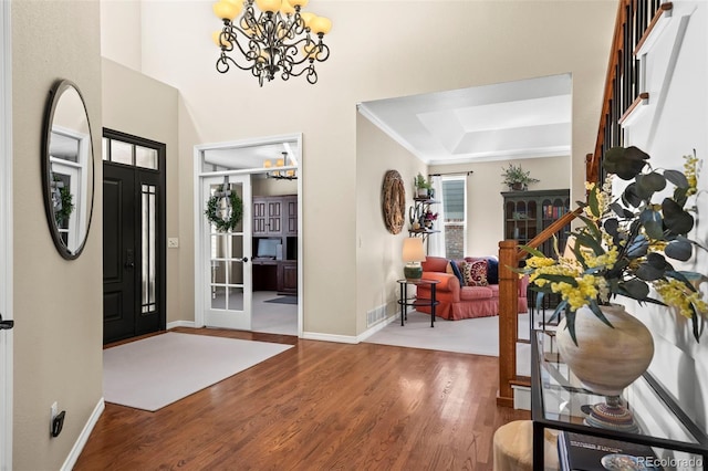 1113 Southbury Pl, Highlands Ranch, CO 80129 - entryway with a chandelier, wood finished floors, baseboards, and plenty of natural light