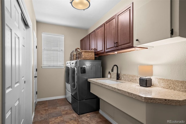 1113 Southbury Pl, Highlands Ranch, CO 80129 - washroom featuring washer and dryer, cabinet space, baseboards, and stone finish floors