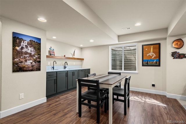 1113 Southbury Pl, Highlands Ranch, CO 80129 - dining area with bar with sink, dark wood-type flooring, baseboards, and recessed lighting