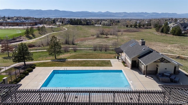 1113 Southbury Pl, Highlands Ranch, CO 80129 - view of swimming pool with a patio area, a mountain view, and a rural view