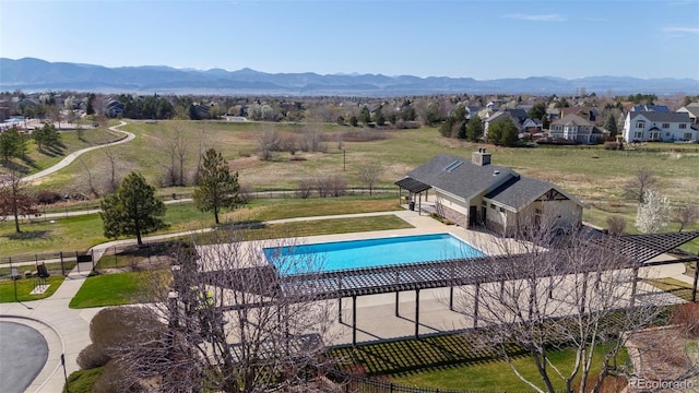1113 Southbury Pl, Highlands Ranch, CO 80129 - view of pool with a mountain view, a patio area, and an outbuilding
