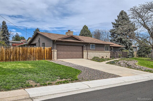 ranch-style house with a chimney, fence, a front lawn, concrete driveway, and a garage