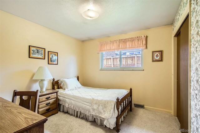bedroom featuring light carpet, baseboards, and visible vents