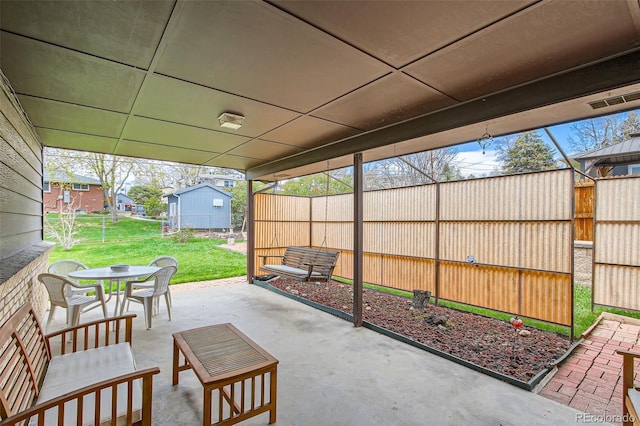 view of patio with outdoor dining area and fence