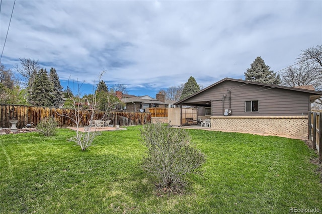 view of yard with a fenced backyard and a patio