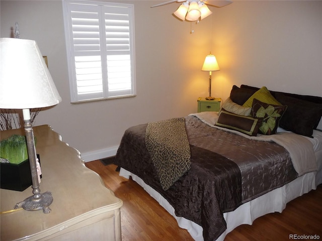 bedroom featuring wood finished floors and baseboards