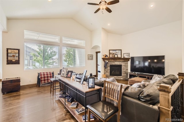 living room with arched walkways, ceiling fan, high vaulted ceiling, a fireplace, and wood finished floors