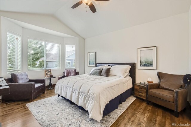 bedroom with lofted ceiling, a ceiling fan, and dark wood-type flooring