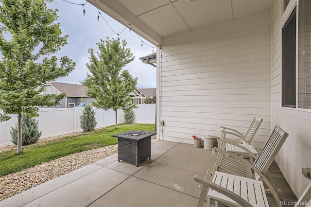 view of patio featuring a fire pit and fence