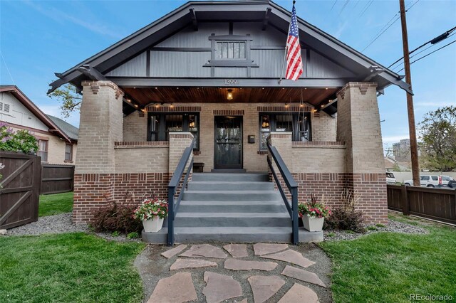 1399 Newton St, Denver, CO 80204 - view of front of house featuring brick siding and covered porch