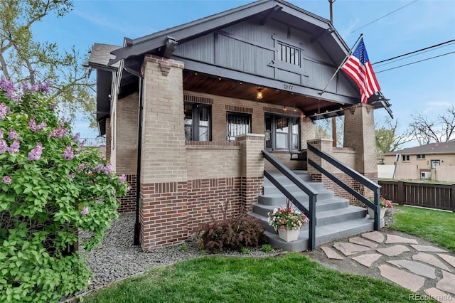 1399 Newton St, Denver, CO 80204 - view of front facade featuring brick siding and covered porch