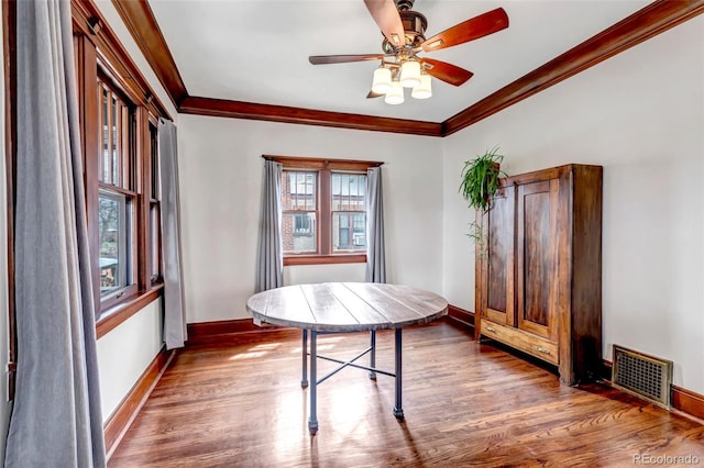 1399 Newton St, Denver, CO 80204 - dining room with wood finished floors, crown molding, and baseboards