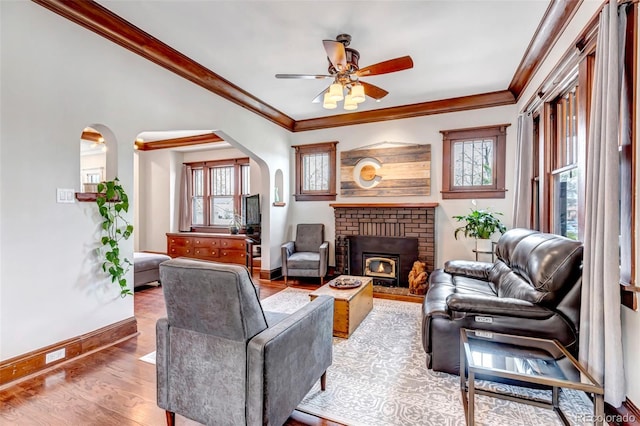 1399 Newton St, Denver, CO 80204 - living area with arched walkways, healthy amount of natural light, a ceiling fan, baseboards, and ornamental molding