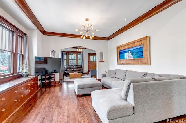 1399 Newton St, Denver, CO 80204 - living room with arched walkways, ornamental molding, wood finished floors, and a chandelier