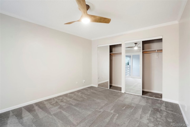 unfurnished bedroom featuring baseboards, ornamental molding, carpet, and two closets