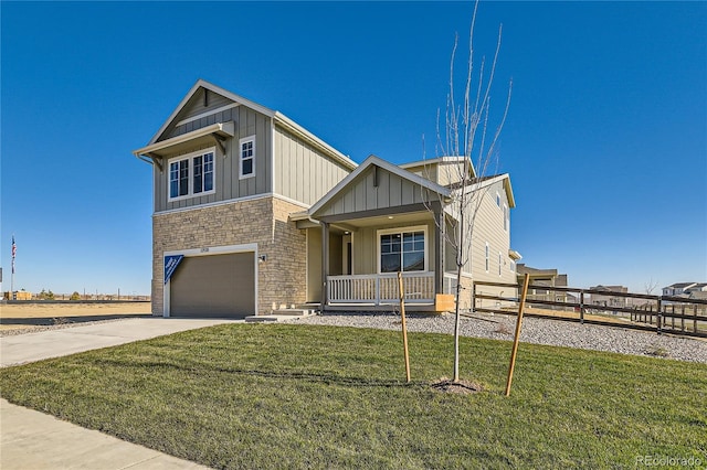 view of front facade featuring a porch, a garage, and a front lawn