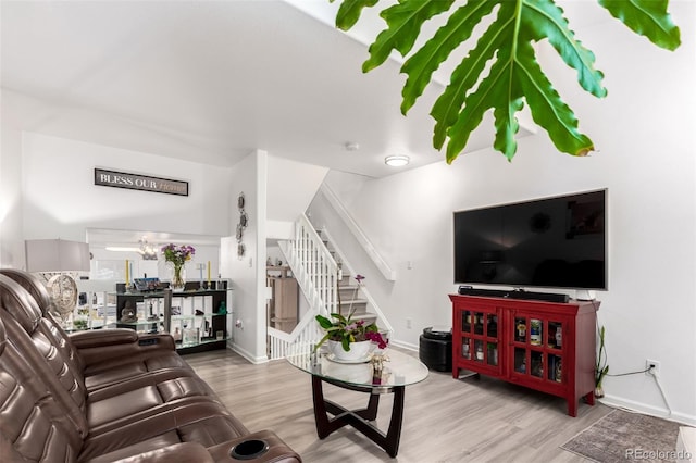 1885 S Quebec Way Unit G 106, Denver, CO 80231 - living room featuring stairway, wood finished floors, and a chandelier