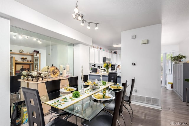 1885 S Quebec Way Unit G 106, Denver, CO 80231 - dining room featuring wood finished floors and rail lighting