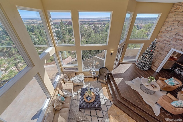 tiled living room with a wealth of natural light and a high ceiling