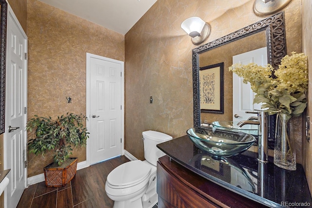 bathroom featuring vanity, wood-type flooring, and toilet