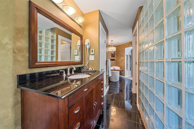 full bath featuring a soaking tub, tile patterned flooring, baseboards, and vanity