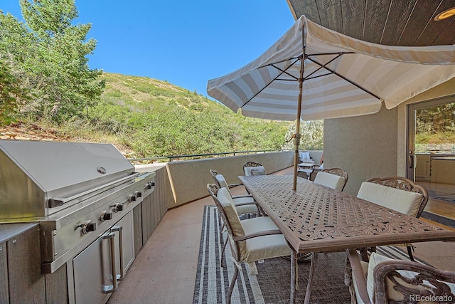 view of patio with a mountain view and area for grilling