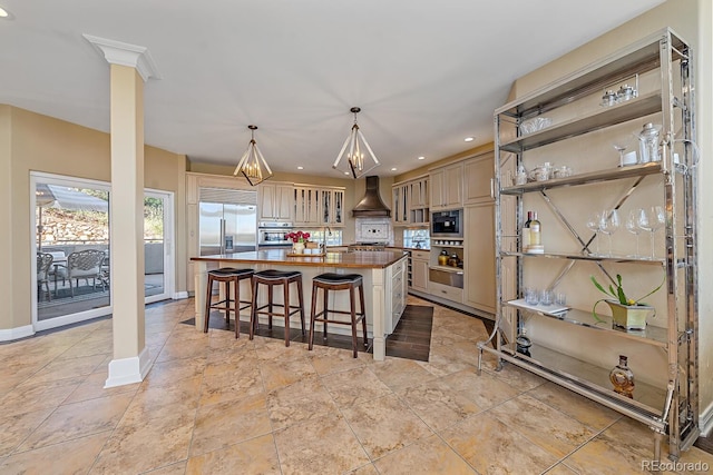 kitchen with a center island, butcher block countertops, custom range hood, appliances with stainless steel finishes, and light tile patterned floors