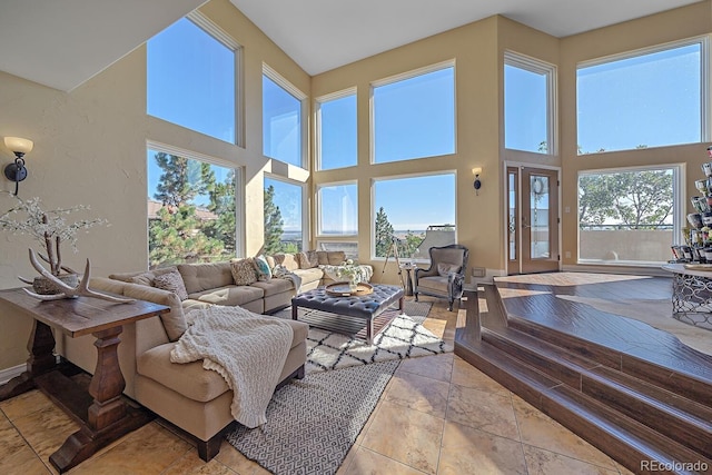 living room featuring light tile patterned floors and a high ceiling