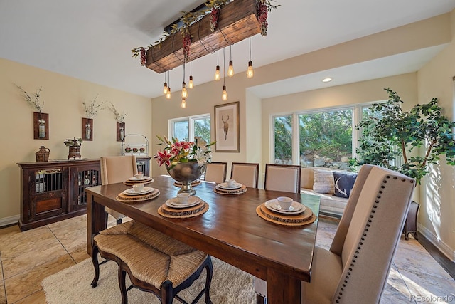 dining area featuring baseboards and light tile patterned floors