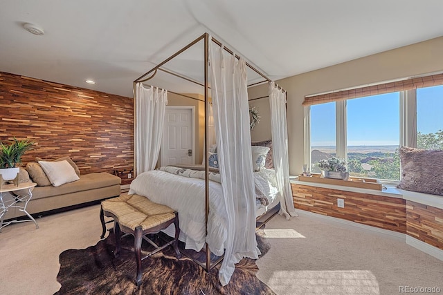 bedroom with carpet flooring and wooden walls