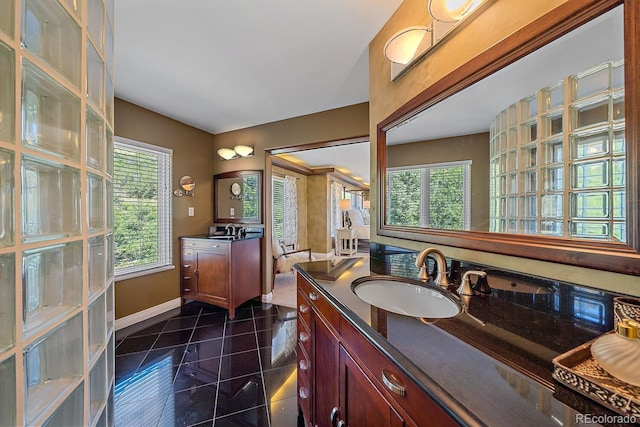 bathroom with tile patterned floors and dual bowl vanity