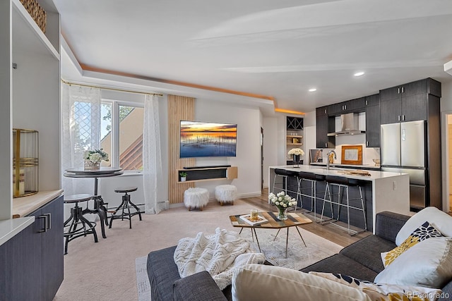 carpeted living room featuring sink