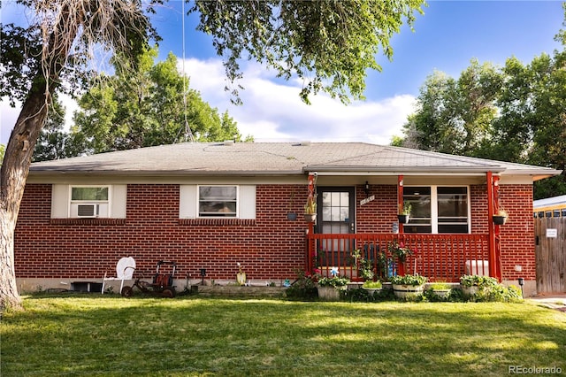 11861 Claude Way, Northglenn, CO 80233 - view of front facade featuring a front lawn, brick siding, roof with shingles, and covered porch