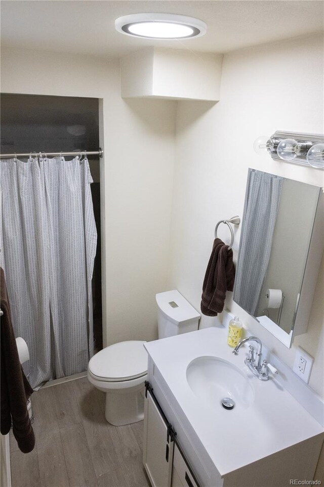 11861 Claude Way, Northglenn, CO 80233 - full bath with wood finished floors, vanity, and curtained shower