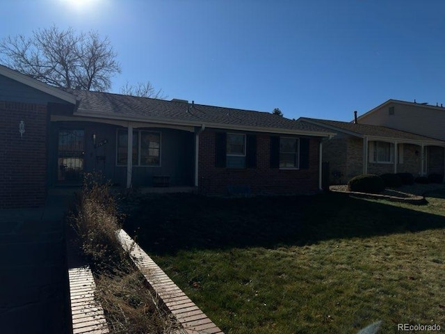 back of house with a lawn