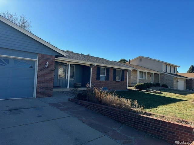 single story home with a front yard and a garage